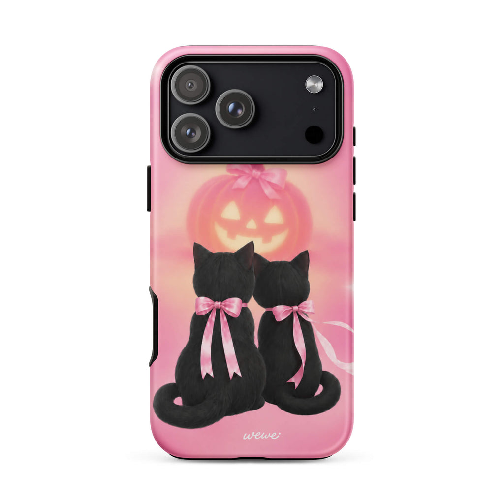 Bubblegum-pink iPhone case with two black cats wearing pink bows and a glowing jack-o-lantern