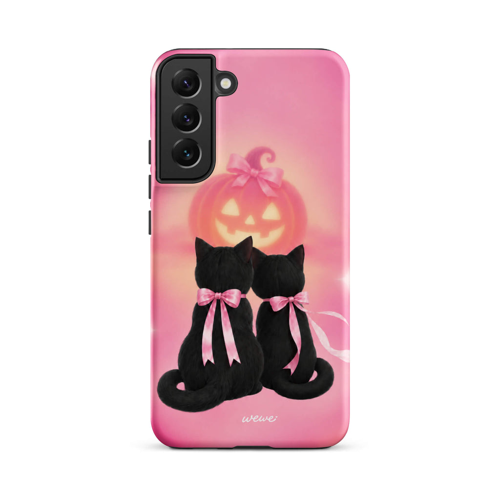 Bubblegum-pink iPhone case with two black cats wearing pink bows and a glowing jack-o-lantern