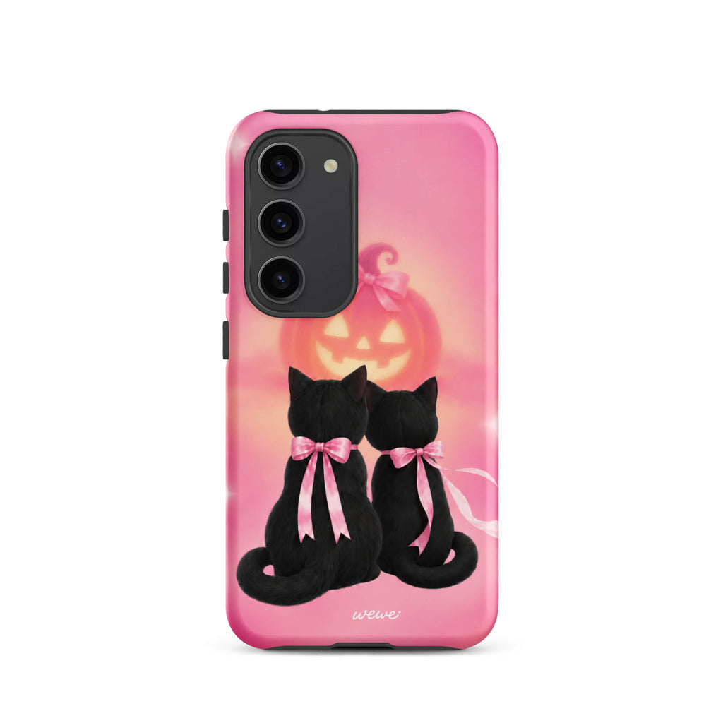 Bubblegum-pink iPhone case with two black cats wearing pink bows and a glowing jack-o-lantern