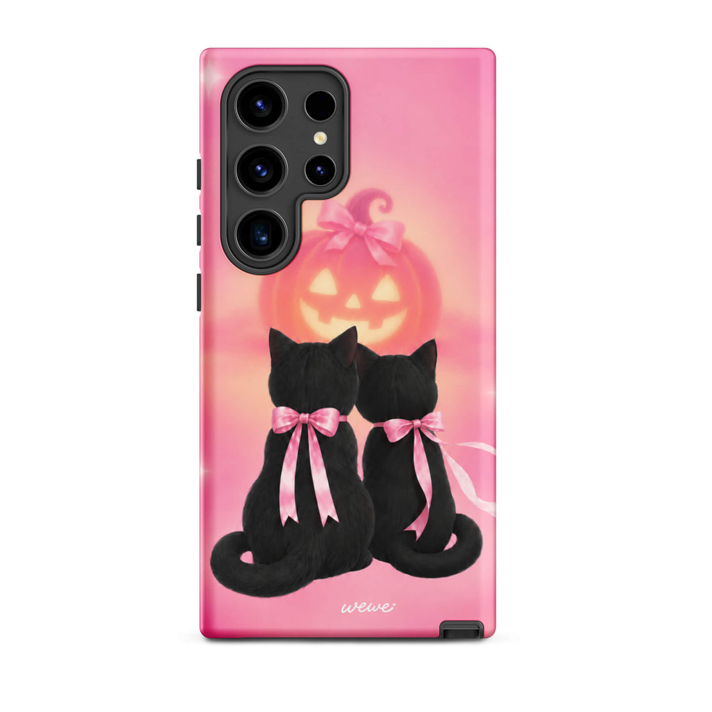 Bubblegum-pink iPhone case with two black cats wearing pink bows and a glowing jack-o-lantern