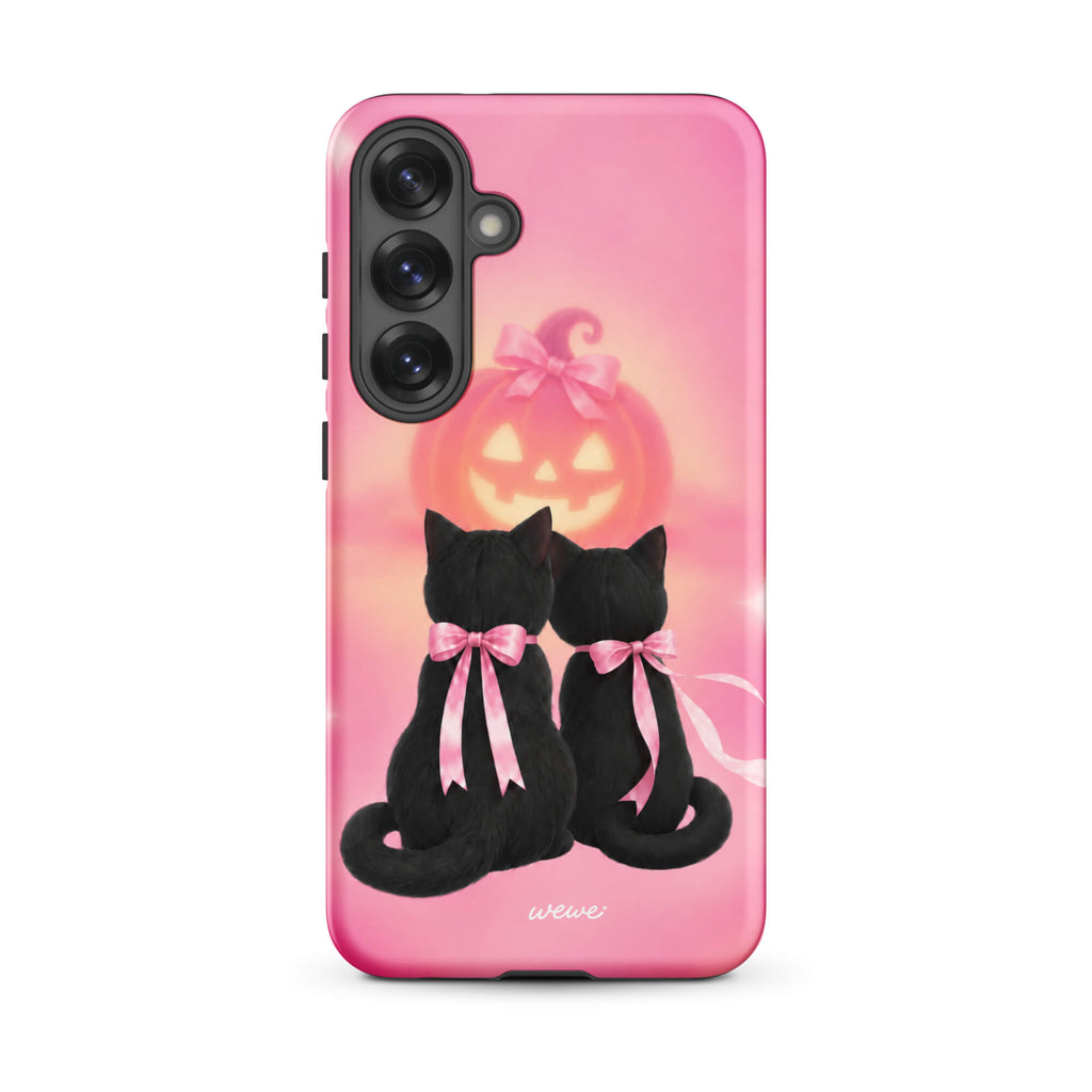 Bubblegum-pink iPhone case with two black cats wearing pink bows and a glowing jack-o-lantern