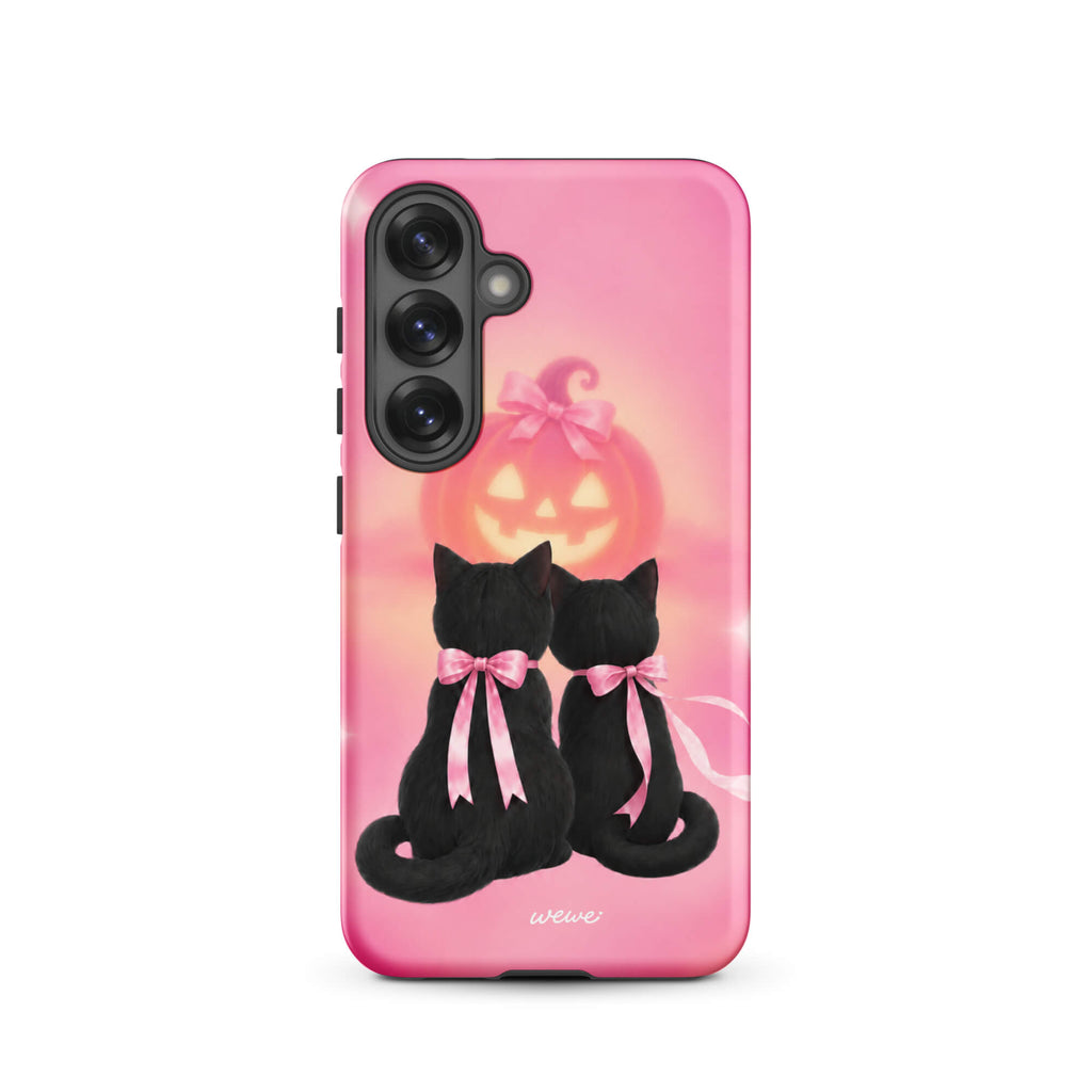 Bubblegum-pink iPhone case with two black cats wearing pink bows and a glowing jack-o-lantern