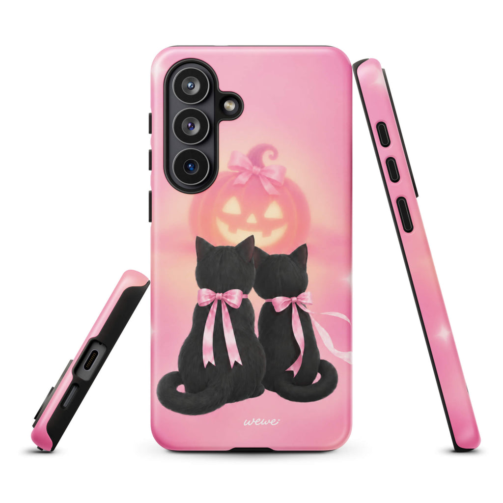 Bubblegum-pink iPhone case with two black cats wearing pink bows and a glowing jack-o-lantern