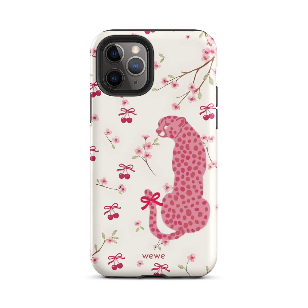 Custom iPhone case 11 pro with a cute pattern of a pink leopard print cheetah and red cherries on a white floral background.
