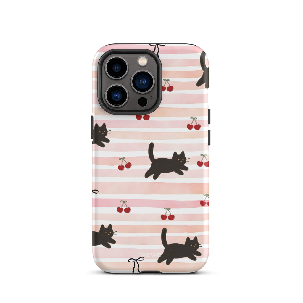 Custom iPhone case 13 pro with a cute pattern of black cats, cherries, and ribbon bows on a pink and white striped background.