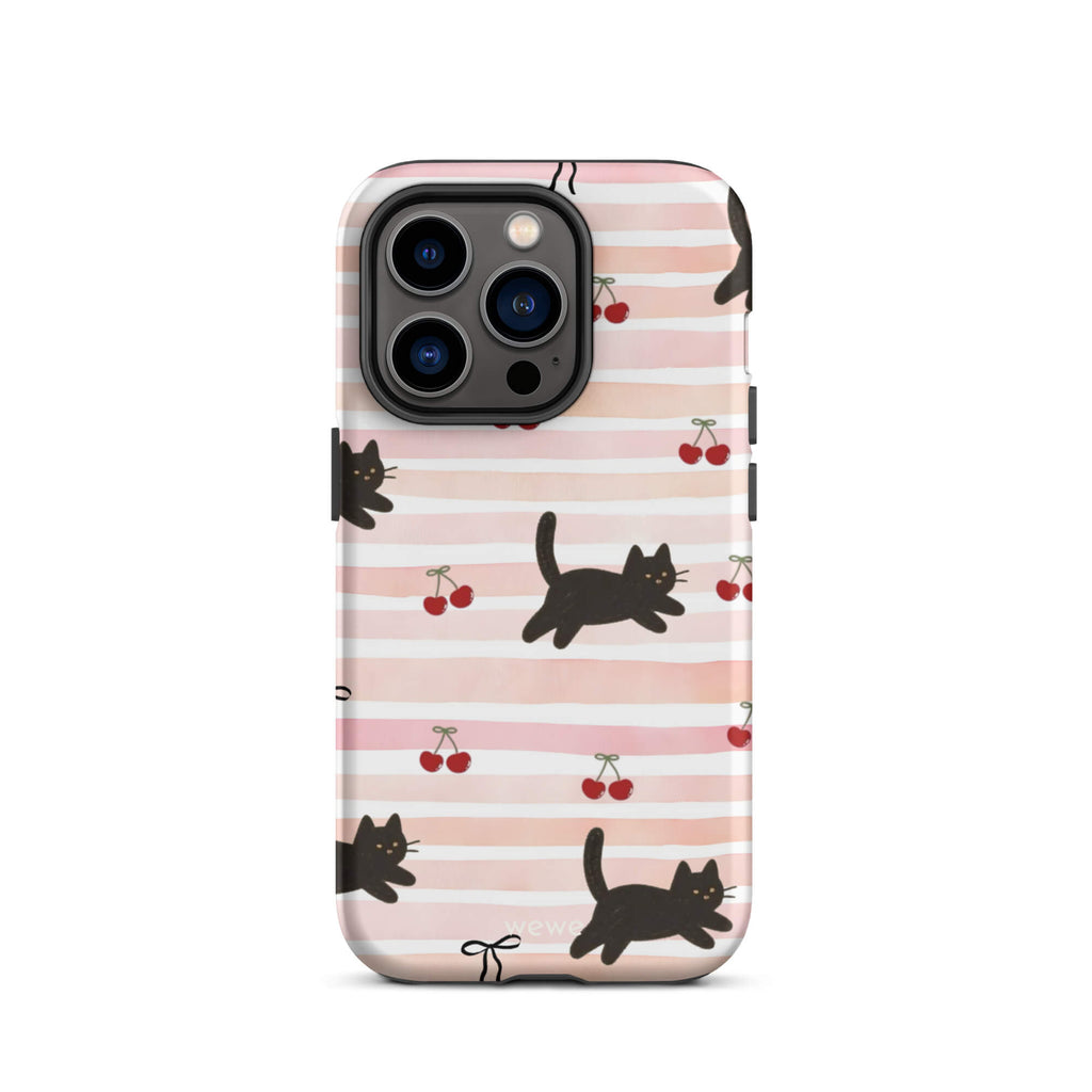 Custom iPhone case 14 pro with a cute pattern of black cats, cherries, and ribbon bows on a pink and white striped background.