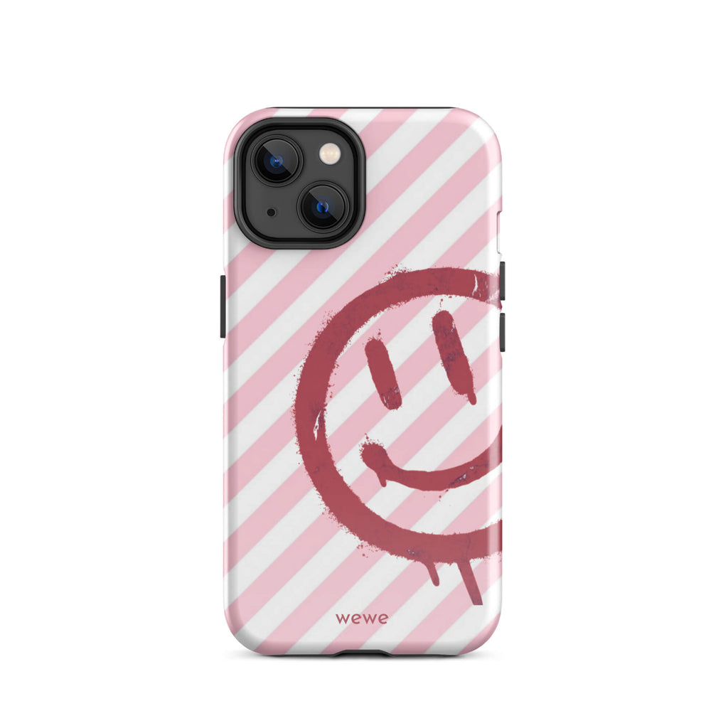 Custom iPhone case 14 with a pink and white diagonal stripe background and a red spray paint graffiti smiley face.