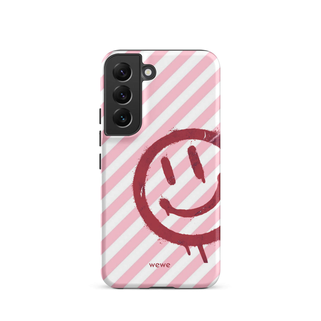 Custom samsung galaxy s22 Phone case with a pink and white diagonal stripe background and a red spray paint graffiti smiley face.
