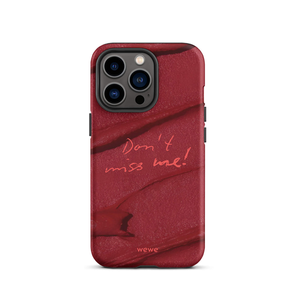 Custom iPhone case 13 pro with a deep red, textured lipstick smudge design and the handwritten text "Don't miss me!".