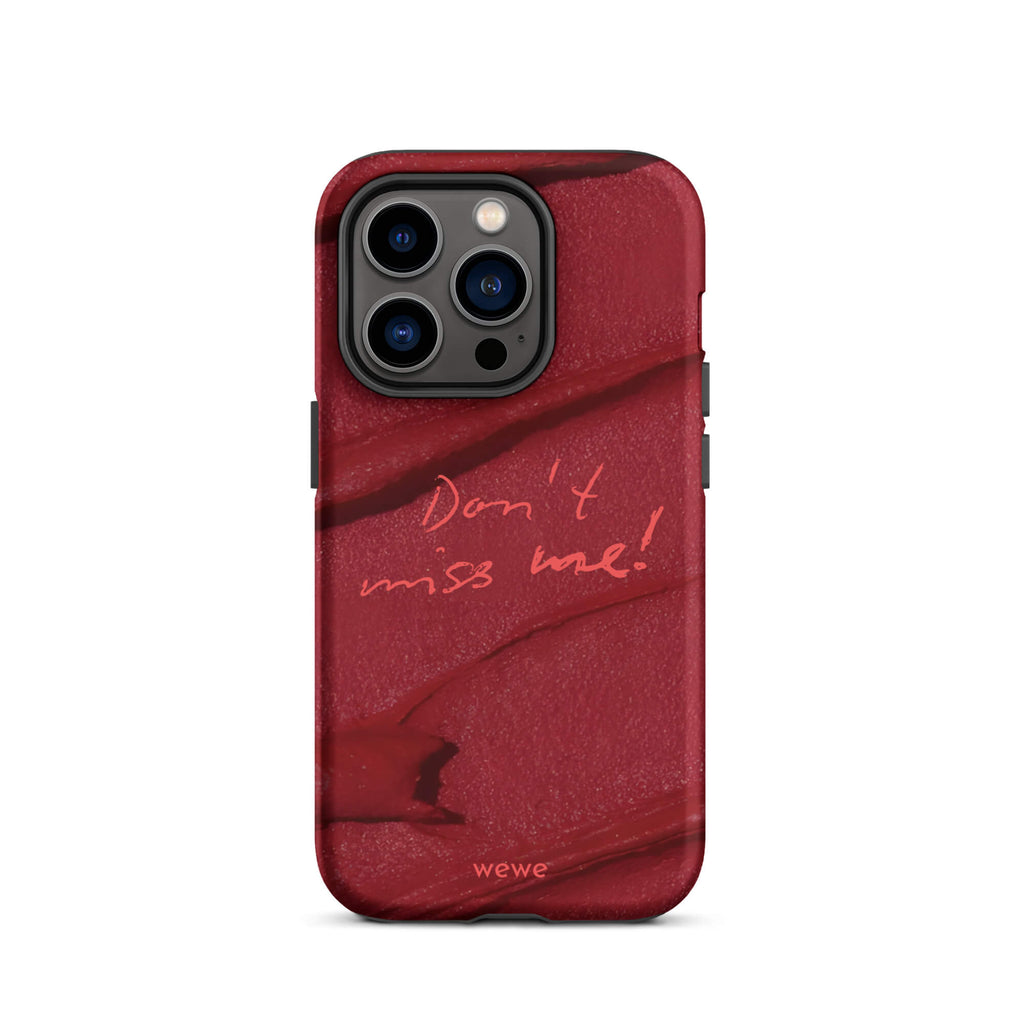 Custom iPhone case 14 pro with a deep red, textured lipstick smudge design and the handwritten text "Don't miss me!".