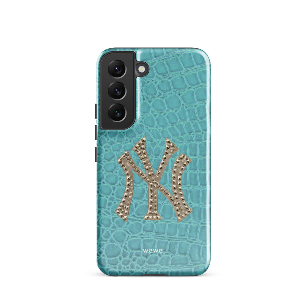 Turquoise crocodile-effect phone case with a large silver rhinestone-style NY monogram