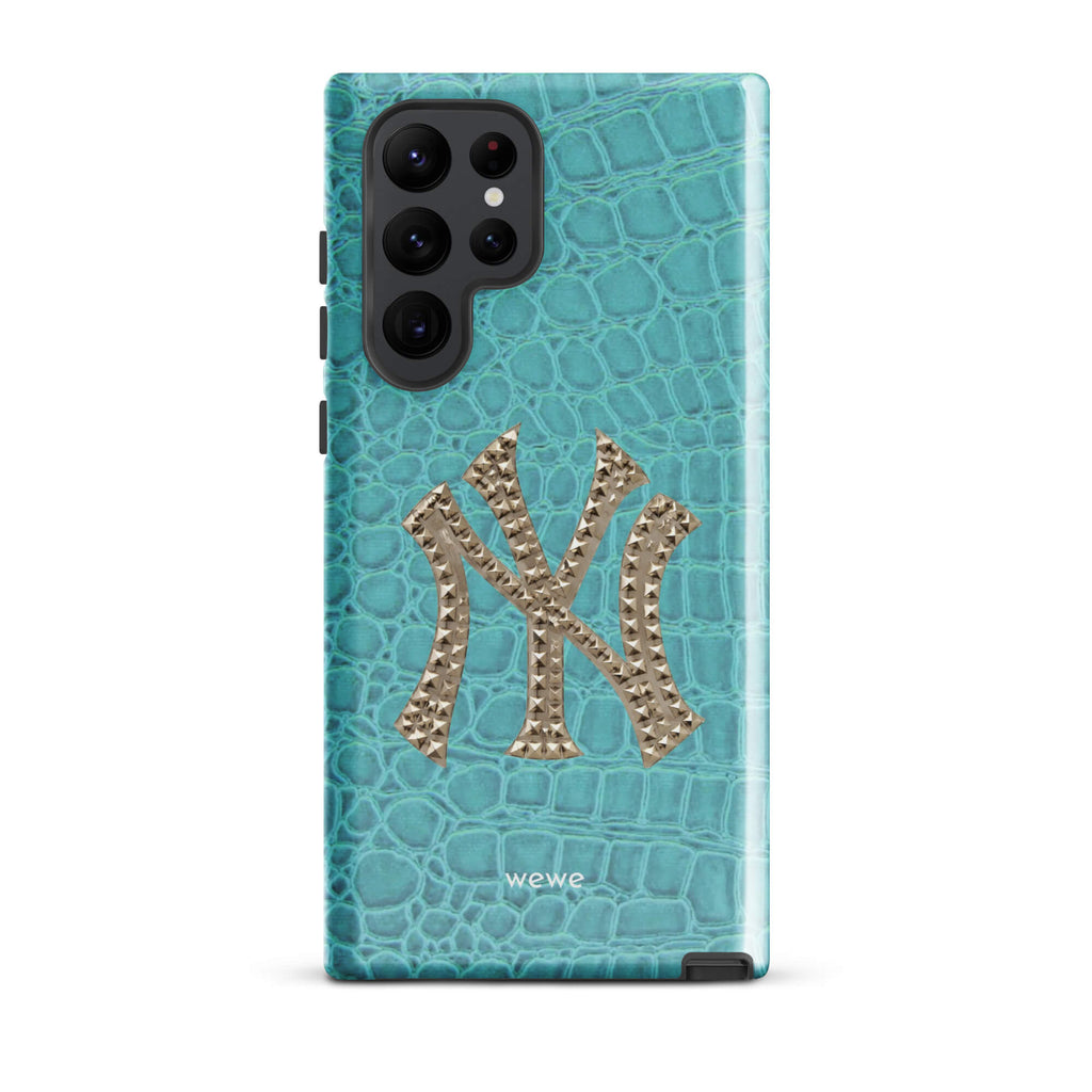 Turquoise crocodile-effect phone case with a large silver rhinestone-style NY monogram
