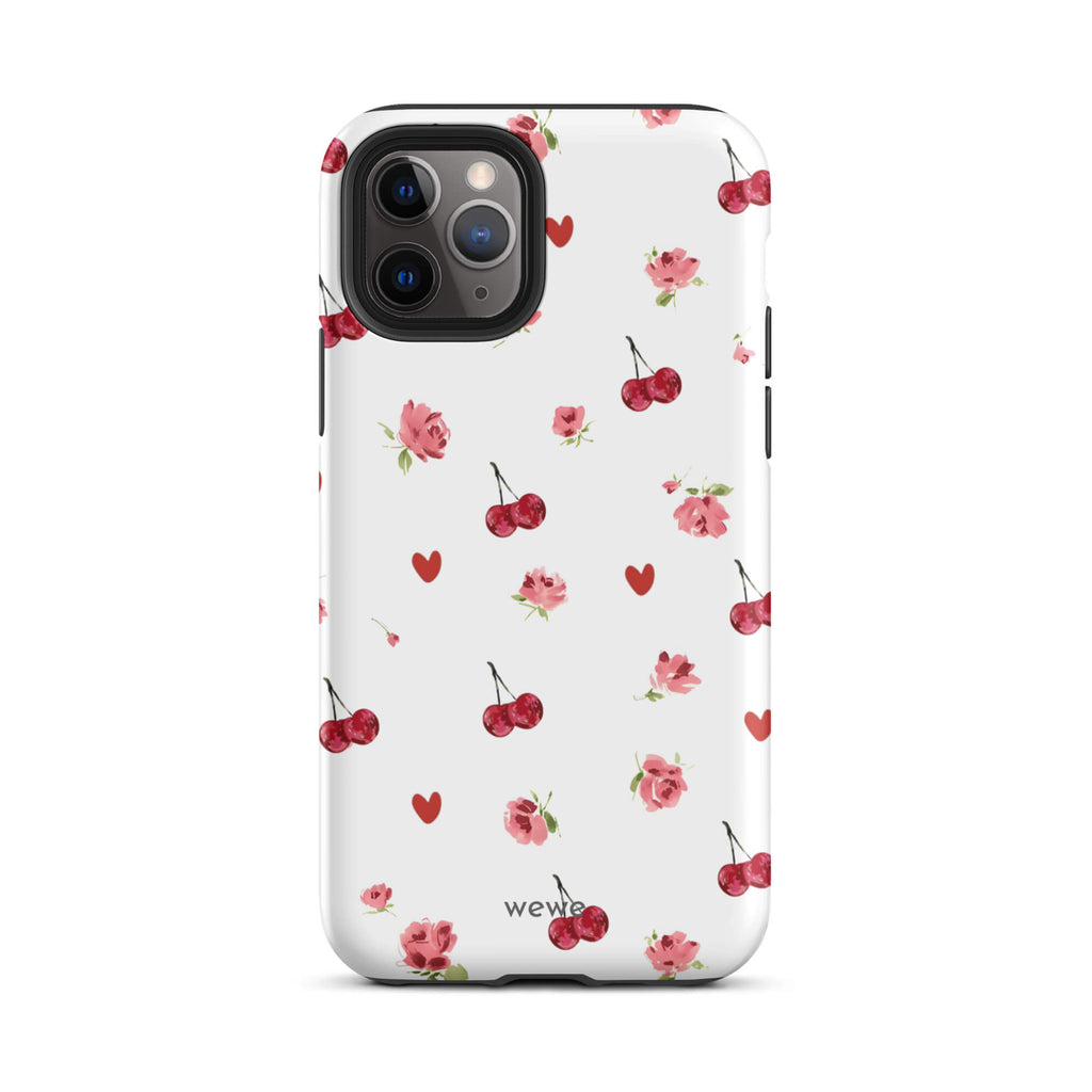 Custom iPhone case 11 pro with a cute and whimsical pattern of watercolor roses, hearts, and cherries on a white background.